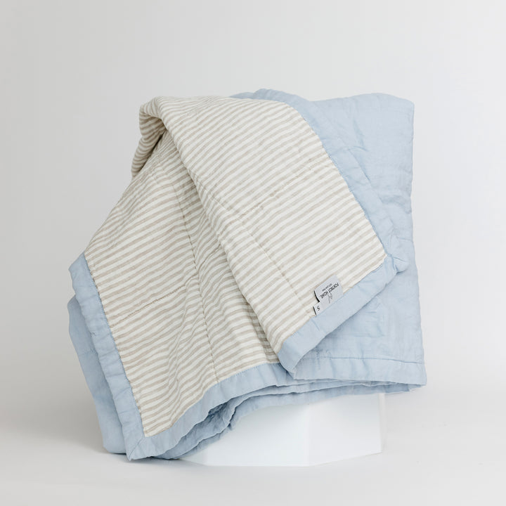 Foxtrot Home French Flax Linen Quilt in Powder Blue with Sand Stripes on the reverse