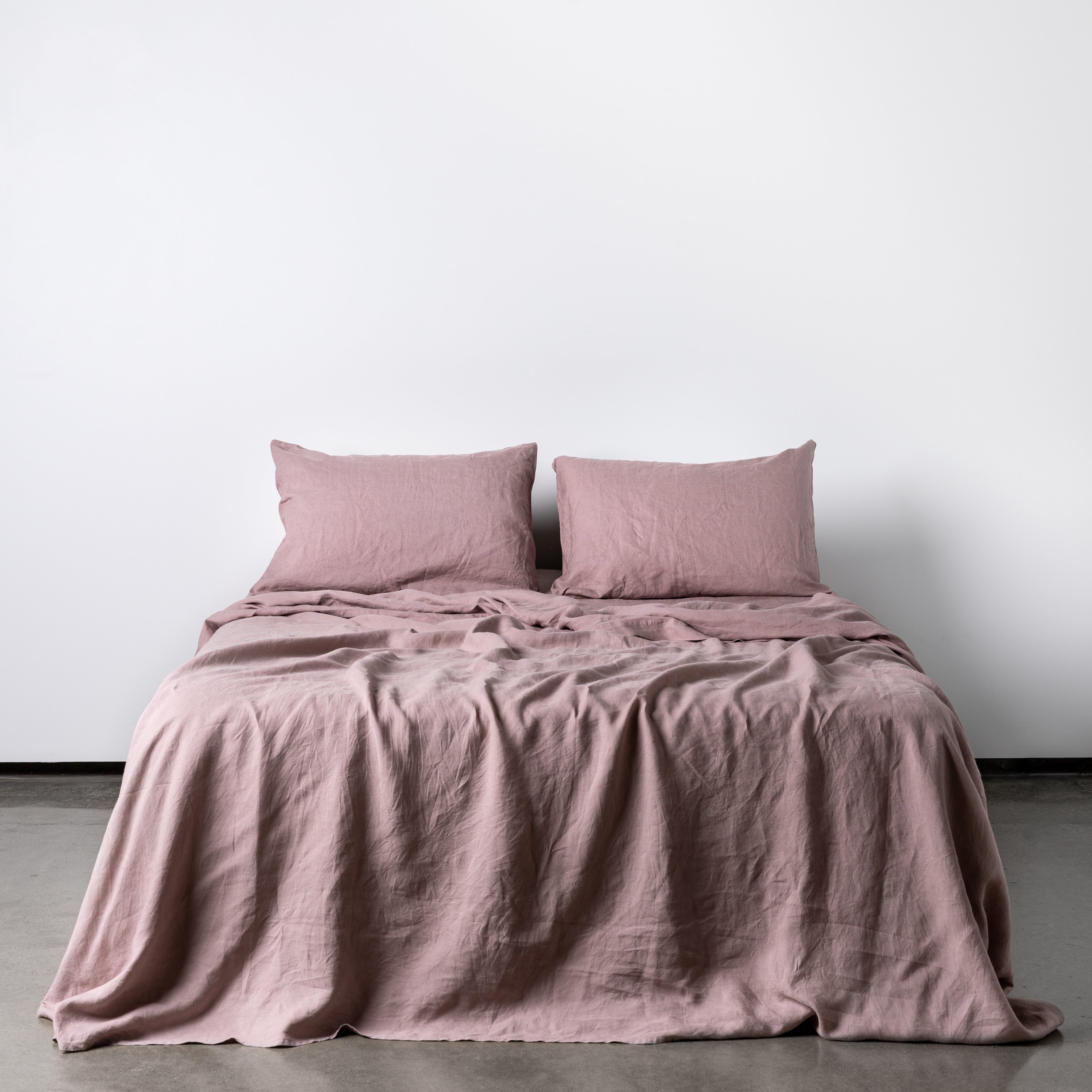 Foxtrot Home French Flax Linen styled in a bedroom with Rosewood Pink Flat Sheet.