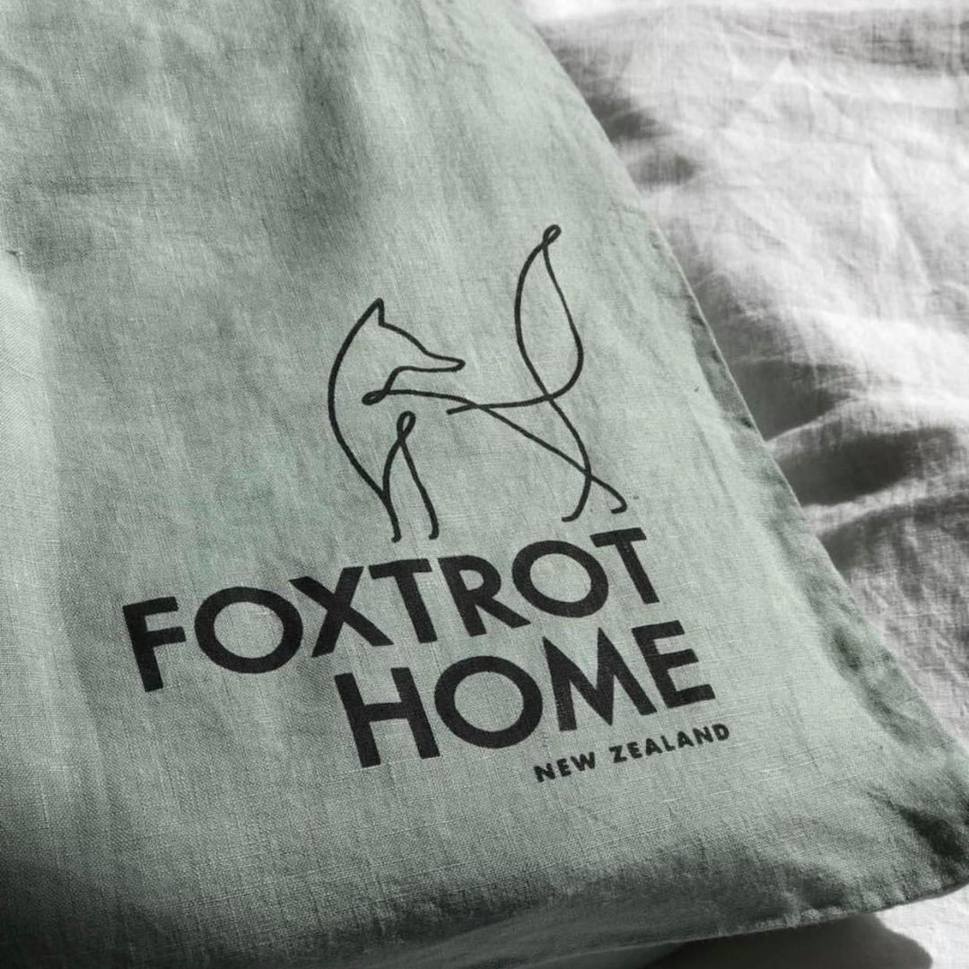 Foxtrot Home French Flax Linen styled in a bedroom with Sage Green Flat Sheet.