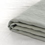Foxtrot Home French Flax Linen styled in a bedroom with Sage Green Sheets Set.