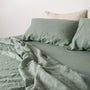 Foxtrot Home French Flax Linen styled in a bedroom with Sage Green Sheets Set.