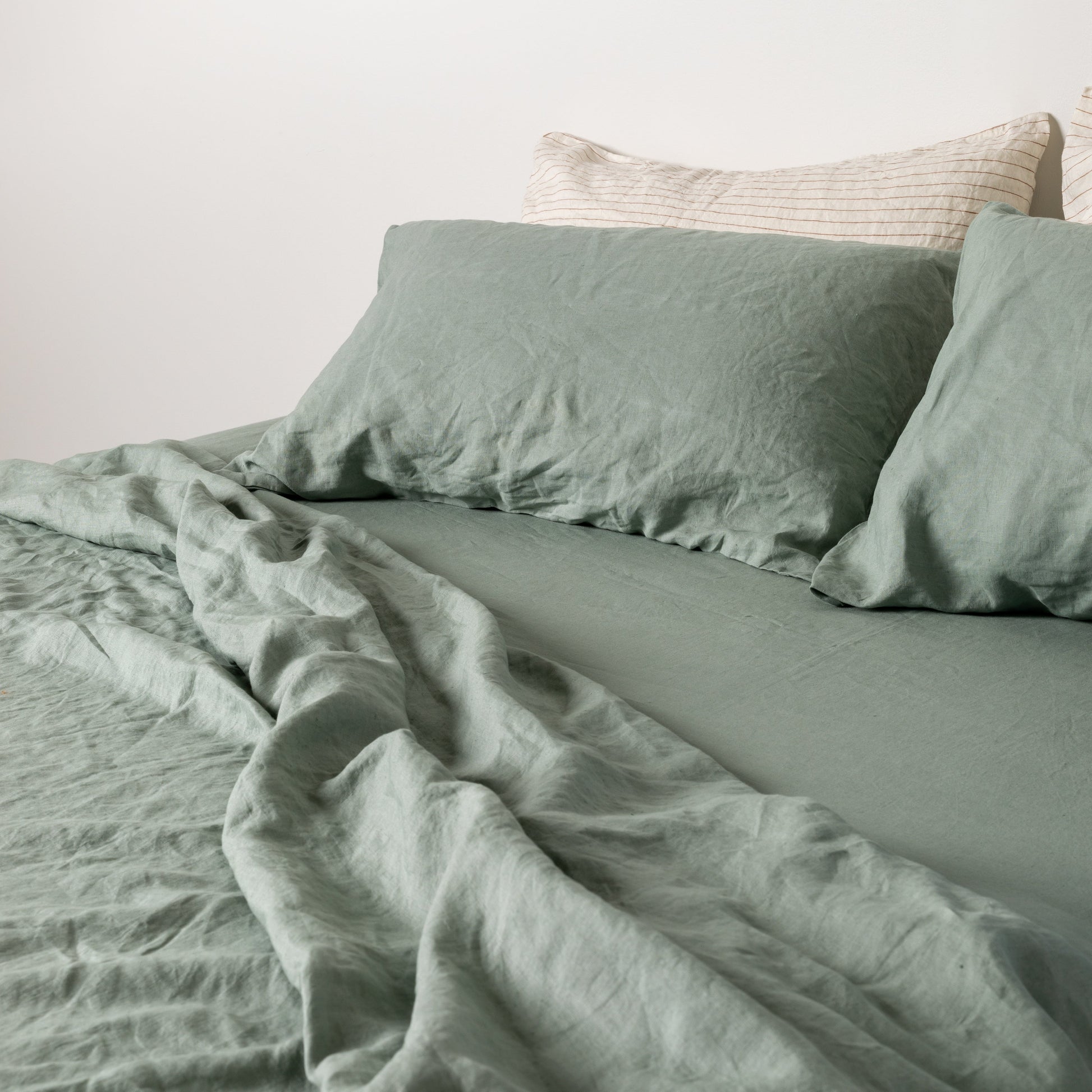 Foxtrot Home French Flax Linen styled in a bedroom with Sage Green Sheets Set.