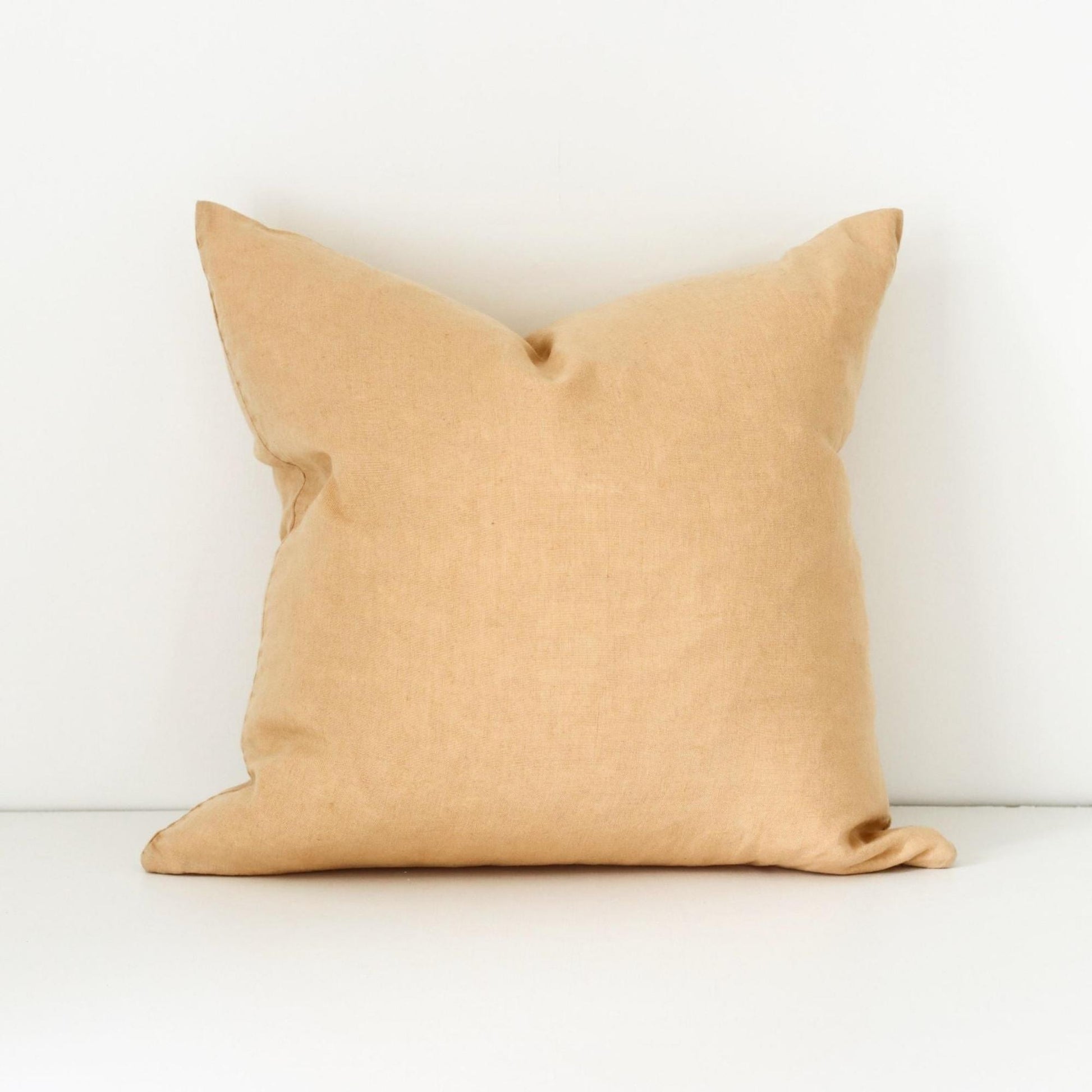 Foxtrot Home French Flax Linen styled in a bedroom with Tawny Peach Cushion Cover.