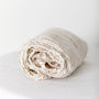 Foxtrot Home French Flax Linen styled in a baby's bedroom with Tobacco Stripes Cot Sheet and Bassinet Sheets.
