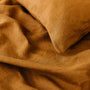 Foxtrot Home French Flax Linen styled in a bedroom with Tobacco Cushion Cover.