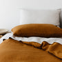 Foxtrot Home French Flax Linen styled in a bedroom with Tobacco Duvet.