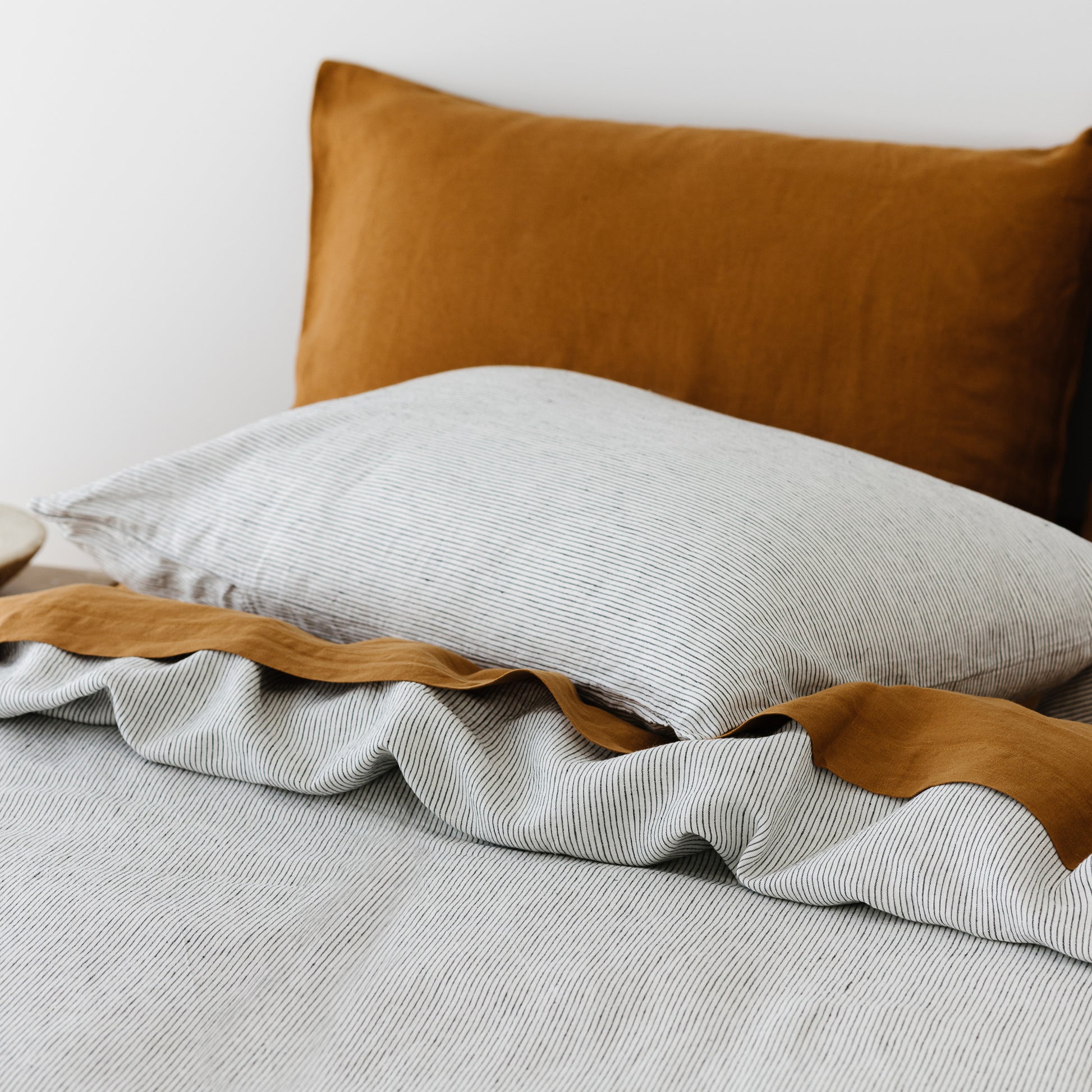 Foxtrot Home French Flax Linen styled in a bedroom with Tobacco Fitted Sheet.