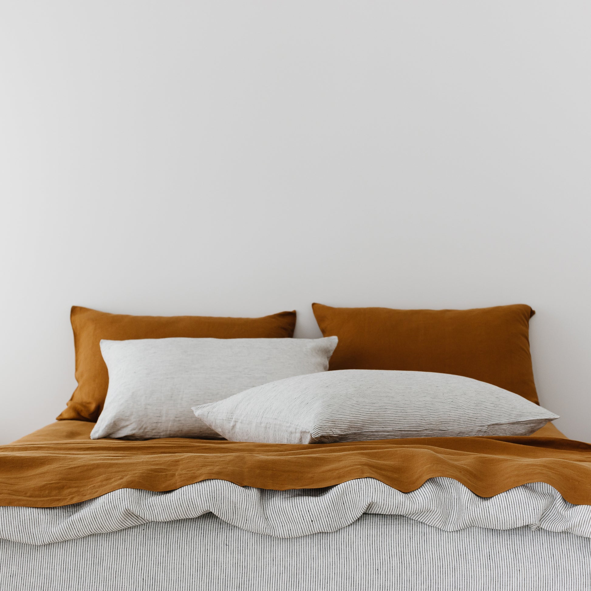 Foxtrot Home French Flax Linen styled in a bedroom with Tobacco Flat Sheet.