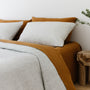 Foxtrot Home French Flax Linen styled in a bedroom with Tobacco Flat Sheet.