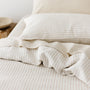 Foxtrot Home French Flax Linen styled in a bedroom with Tobacco Stripes Duvet, Oat Sheets Set and Pillowcases.