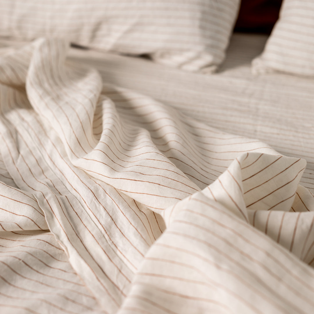Foxtrot Home French Flax Linen styled in a bedroom with Tobacco Stripes Fitted Sheet.