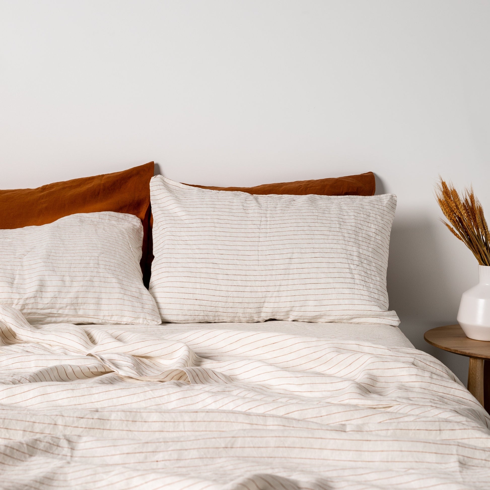 Foxtrot Home French Flax Linen styled in a bedroom with Tobacco Stripes Flat Sheet.