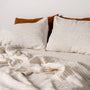 Foxtrot Home French Flax Linen styled in a bedroom with Tobacco Stripes Flat Sheet.