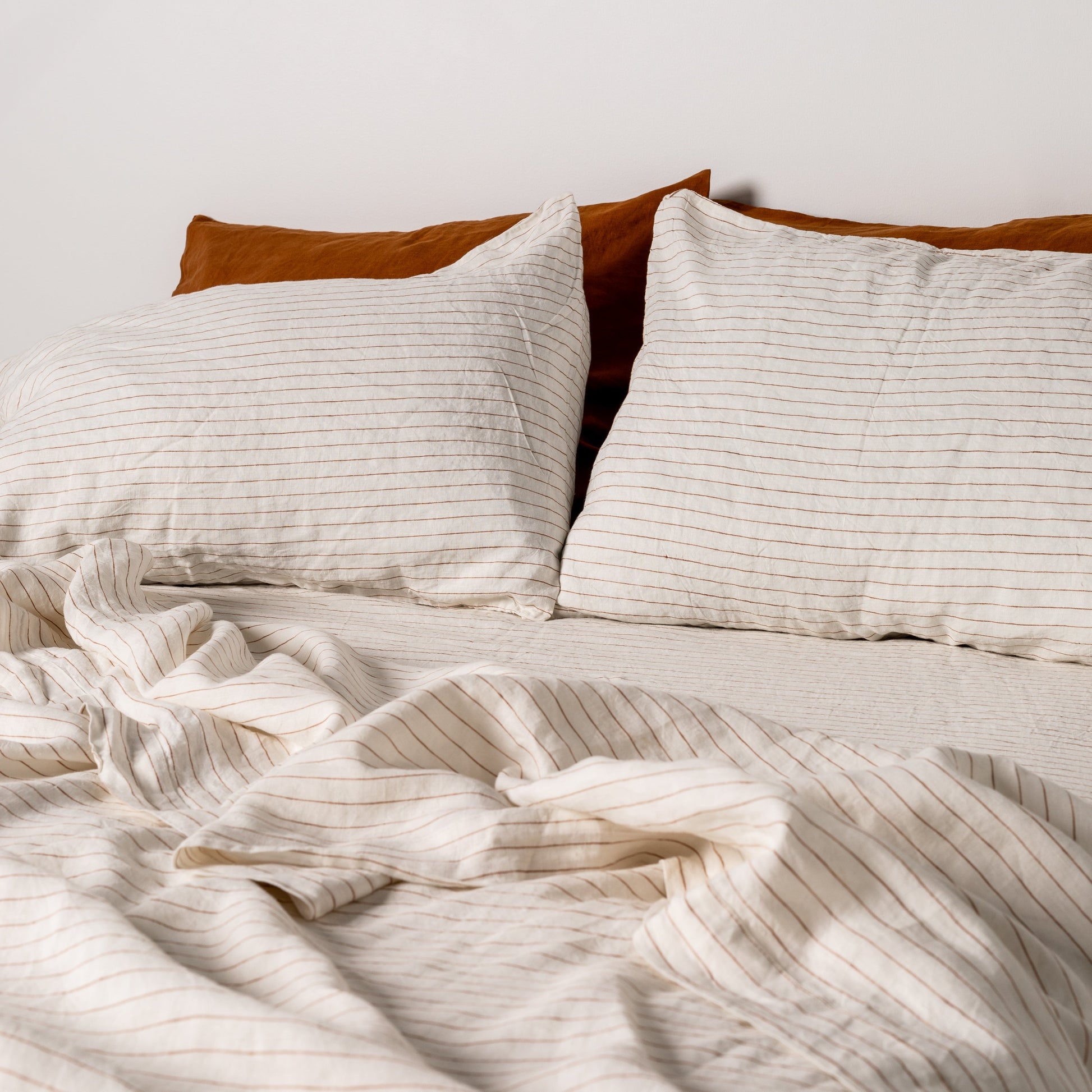 Foxtrot Home French Flax Linen styled in a bedroom with Tobacco Stripes Pillowcases.