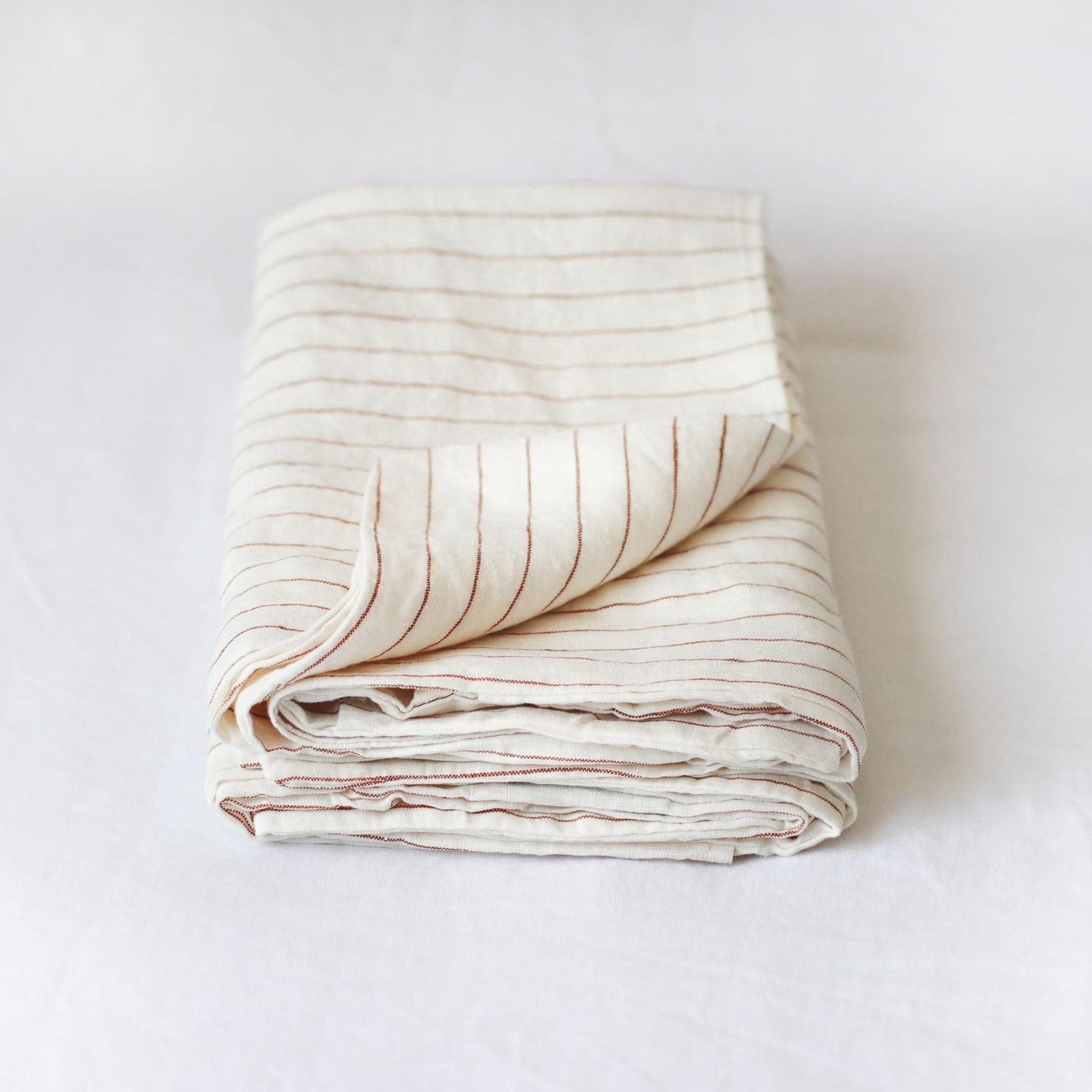Foxtrot Home French Flax Linen styled in a bedroom with Tobacco Stripes Pillowcases.