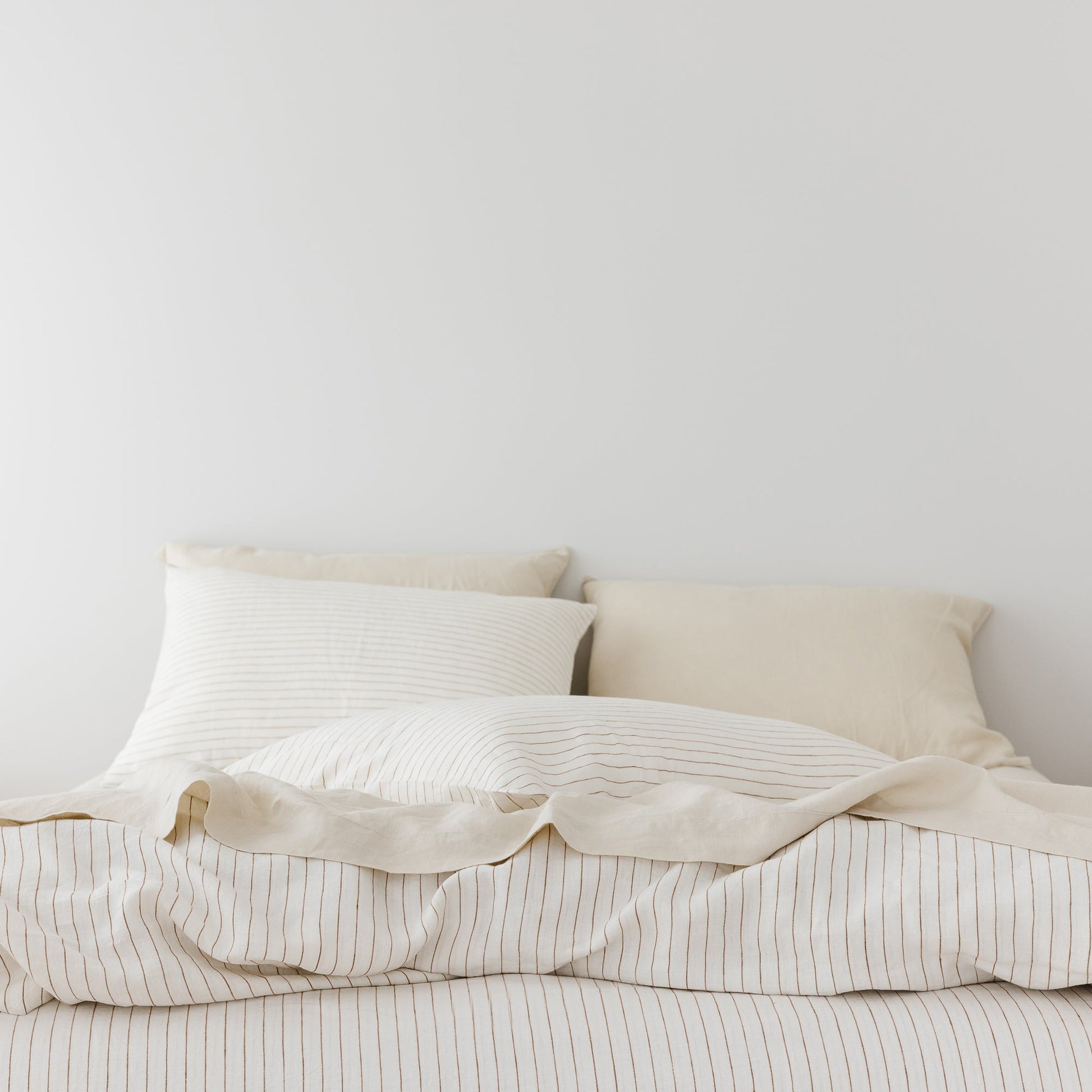 Foxtrot Home French Flax Linen styled in a bedroom with Tobacco Stripes Pillowcases.