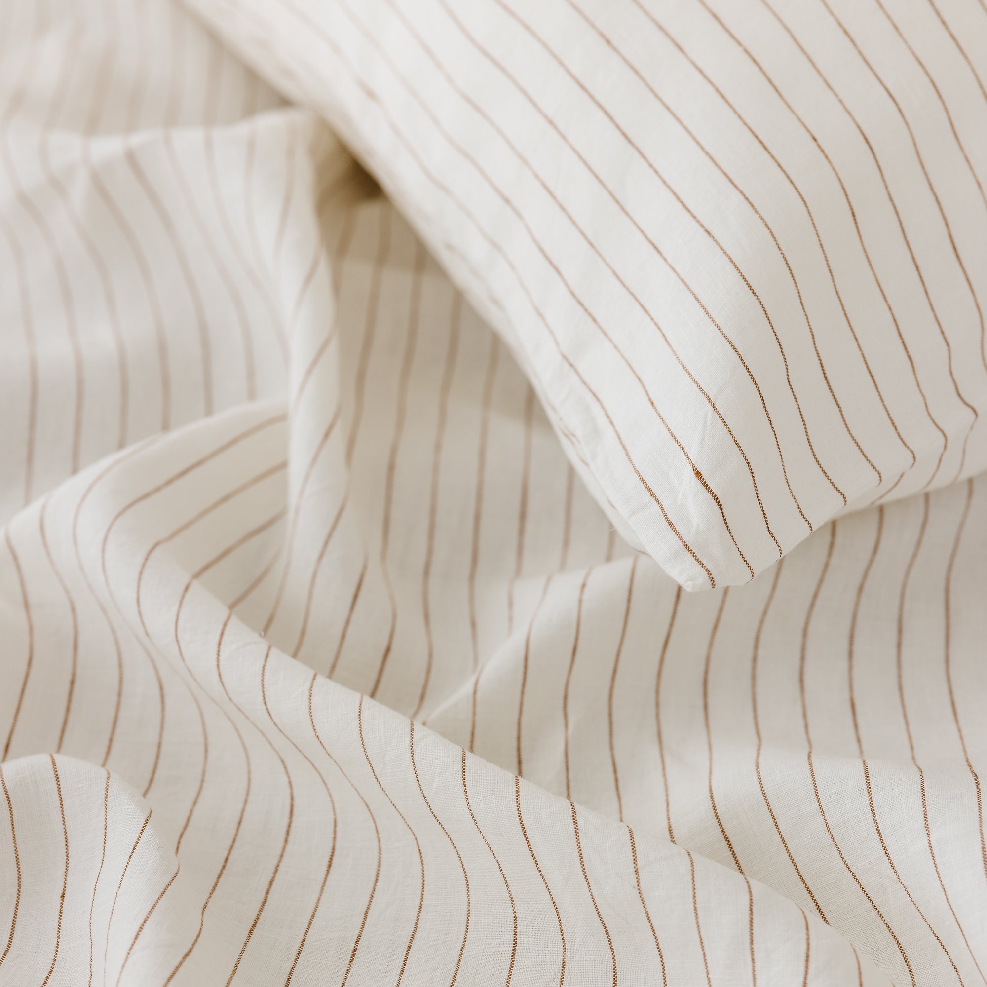 Foxtrot Home French Flax Linen styled in a bedroom with Tobacco Stripes Pillowcases.