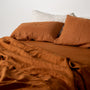 Foxtrot Home French Flax Linen styled in a bedroom with Tobacco Stripes Pillowcases.