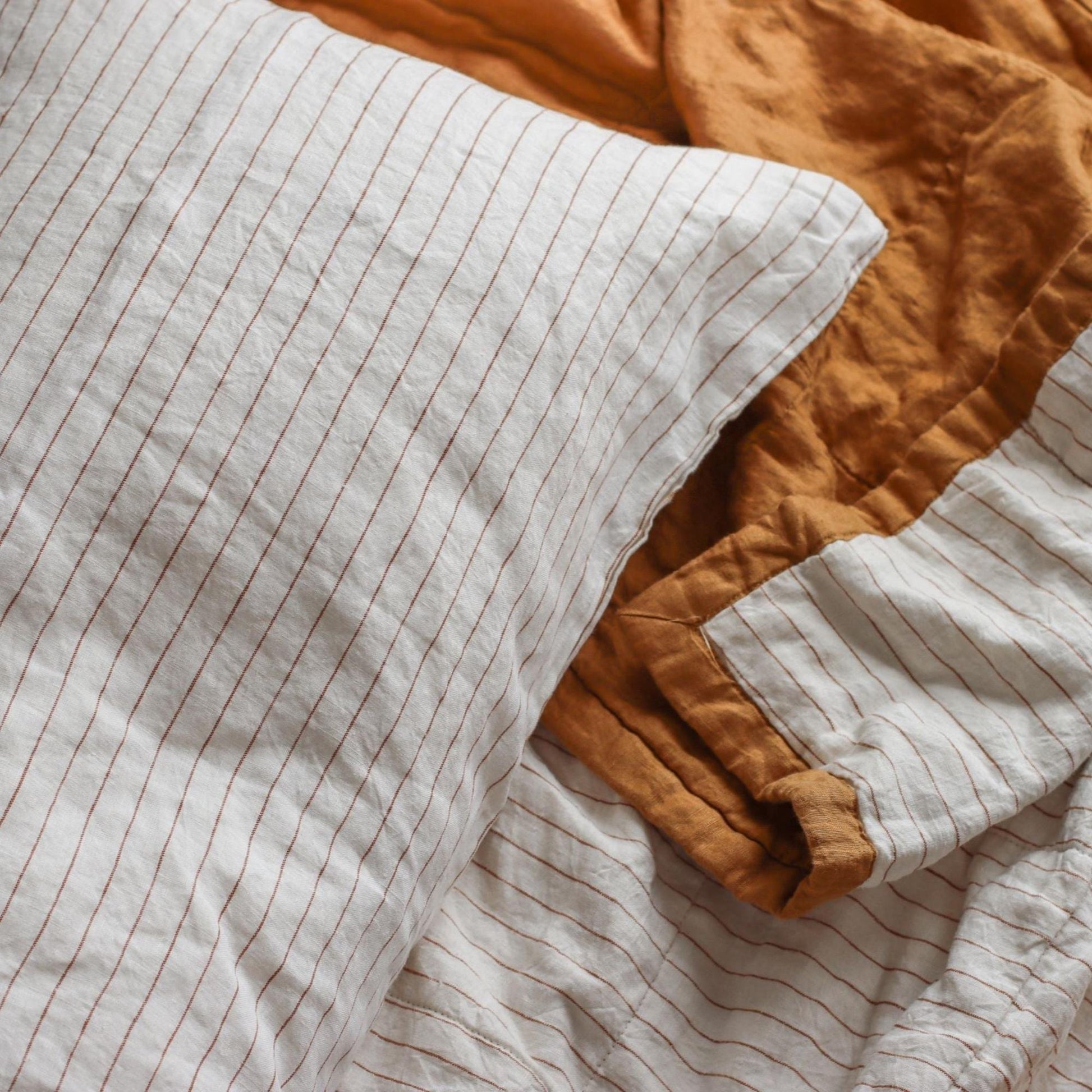 Foxtrot Home French Flax Linen styled in a bedroom with Tobacco Stripes Pillowcases.