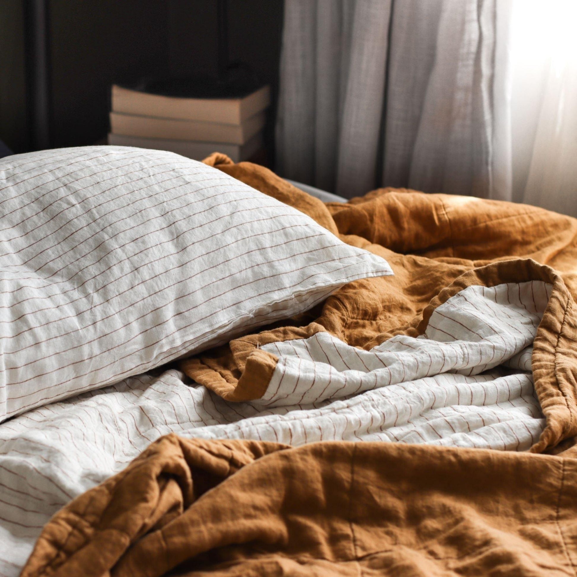Foxtrot Home French Flax Linen styled in a bedroom with Tobacco Stripes Pillowcases.