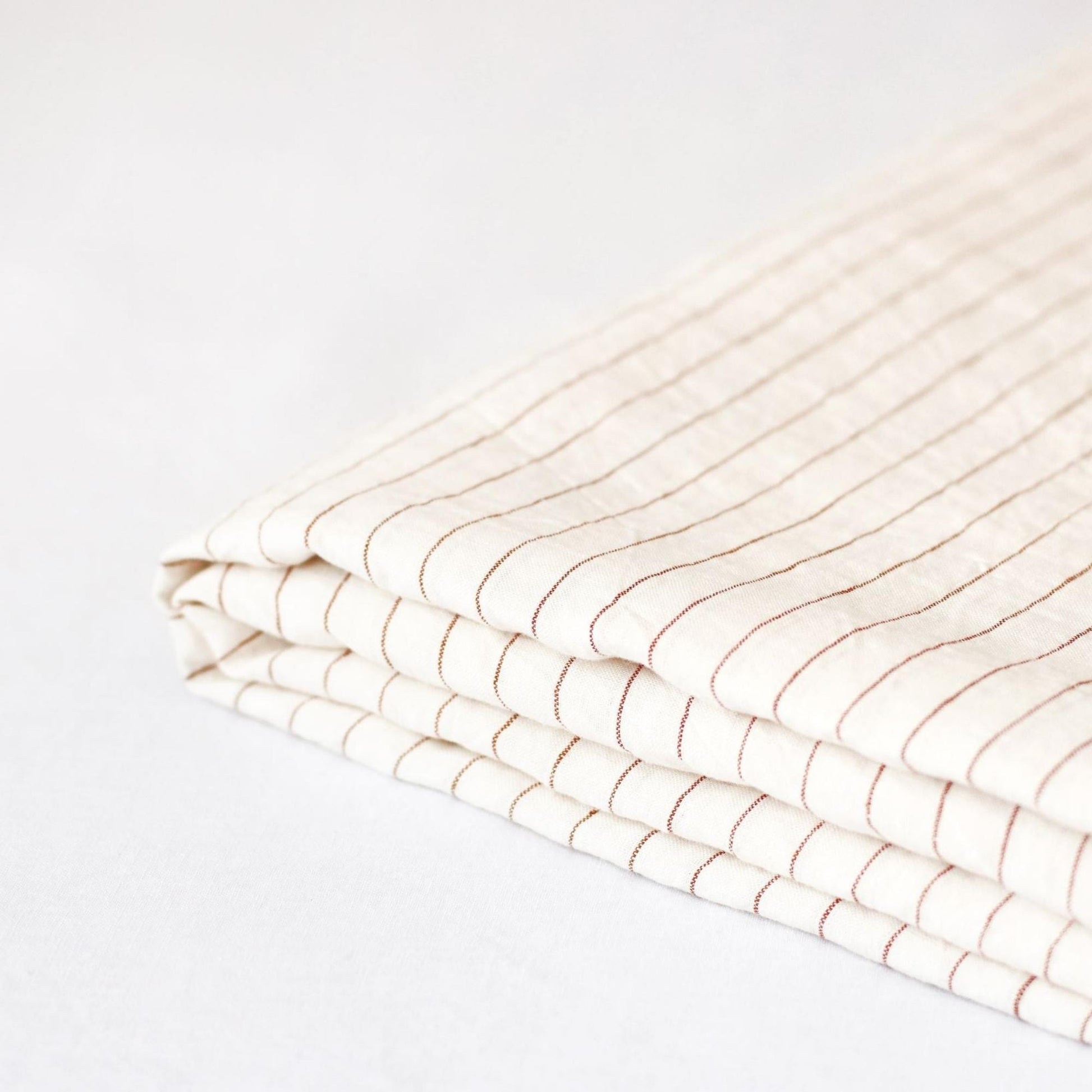 Foxtrot Home French Flax Linen styled in a bedroom with Tobacco Stripes Sheets Sets.