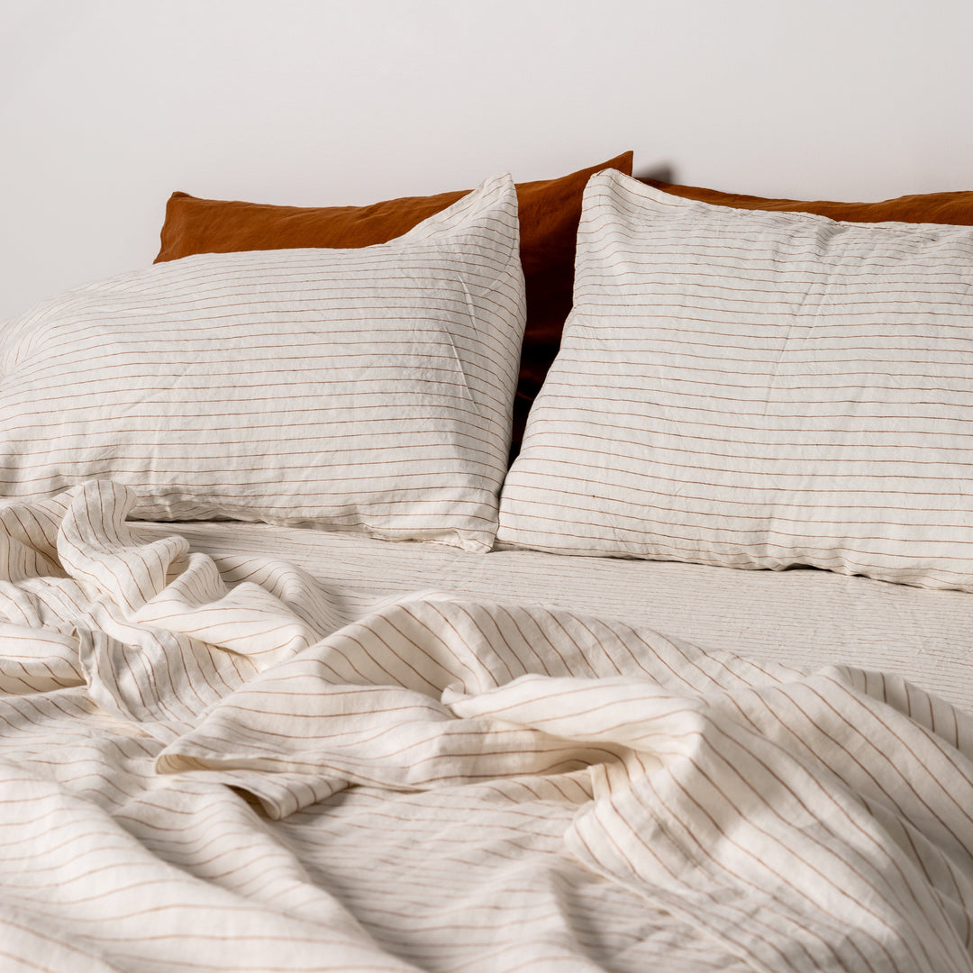 Foxtrot Home French Flax Linen styled in a bedroom with Tobacco Stripes Sheets Sets.