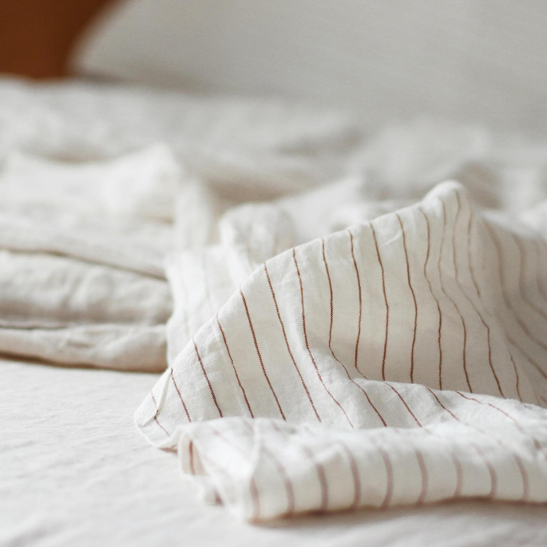 Foxtrot Home French Flax Linen styled in a bedroom with Tobacco Stripes Sheets Sets.