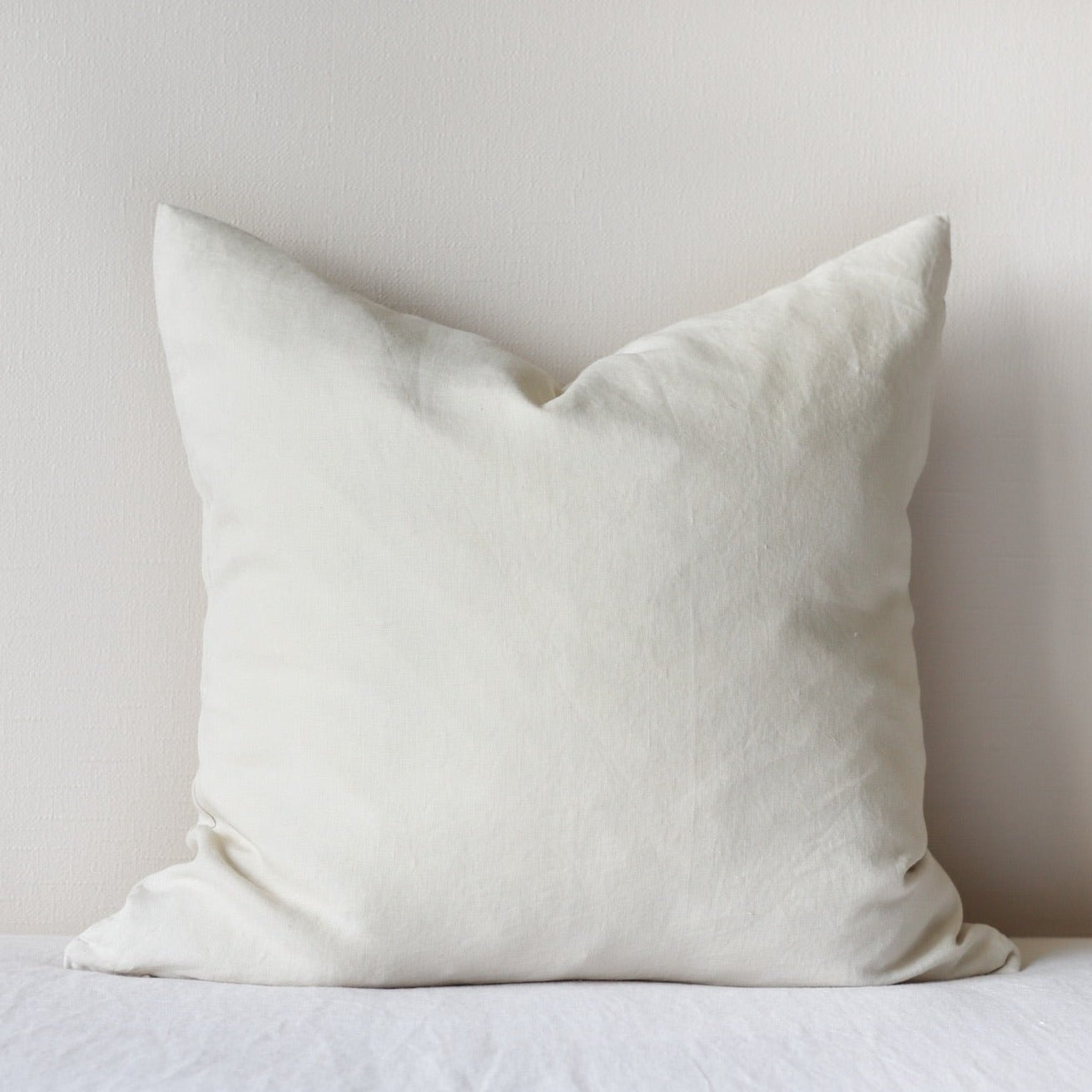 Foxtrot Home French Flax Linen styled in a bedroom with Oat Cushion Cover.
