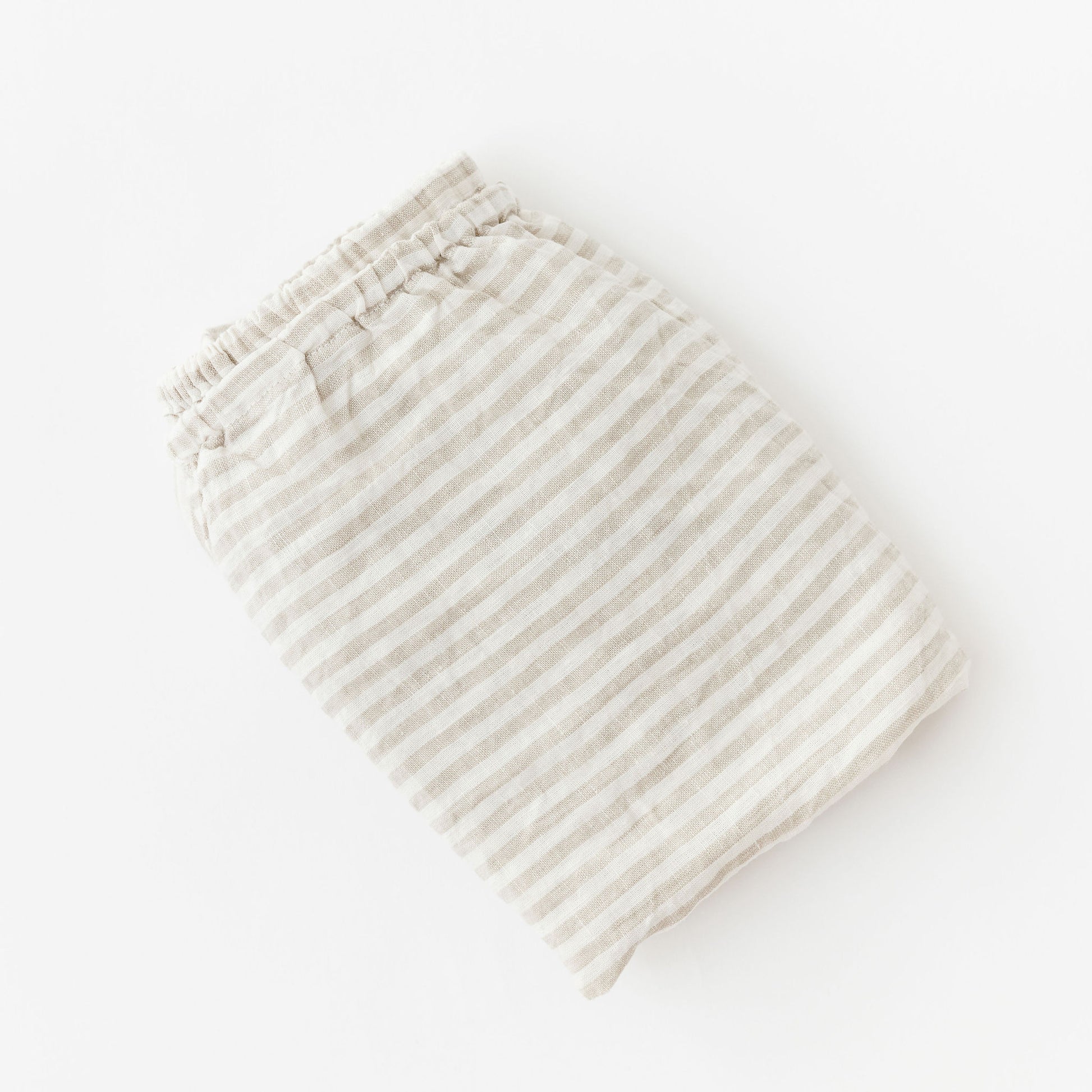 Foxtrot Home French Flax Linen styled in a baby's bedroom with Sand Stripes Cot Sheet and Bassinet Sheets.