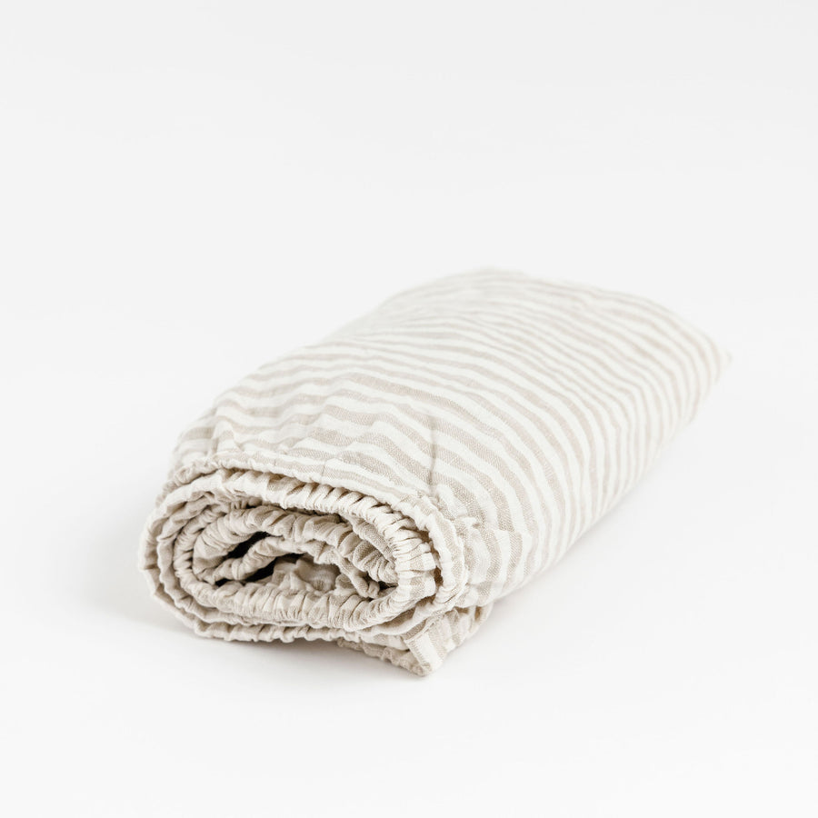 Foxtrot Home French Flax Linen styled in a baby's bedroom with Sand Stripes Cot Sheet and Bassinet Sheets.