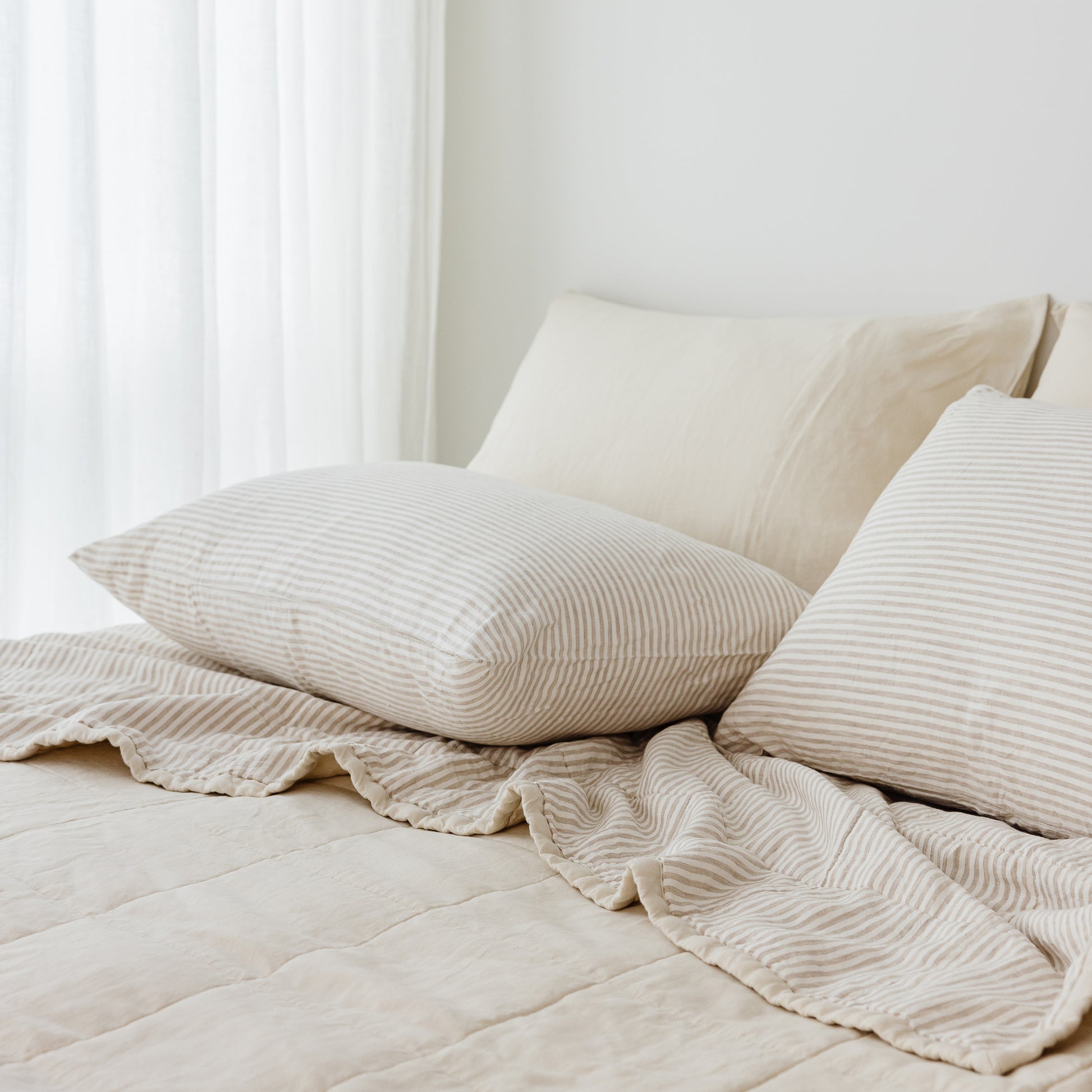 Foxtrot Home French Flax Linen Quilt in Oat with Sand Stripes on the reverse