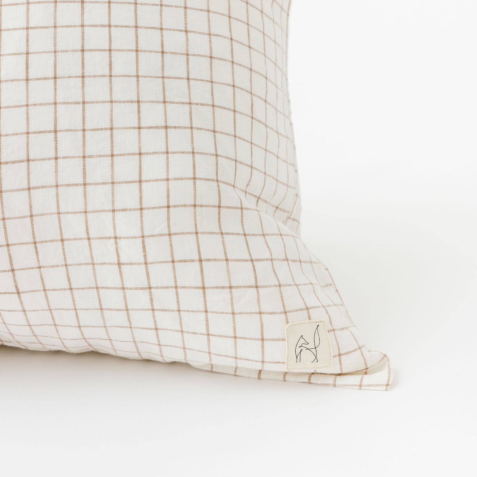 Foxtrot Home French Flax Linen styled in a bedroom with Malt Brown Grid Cushion Cover.